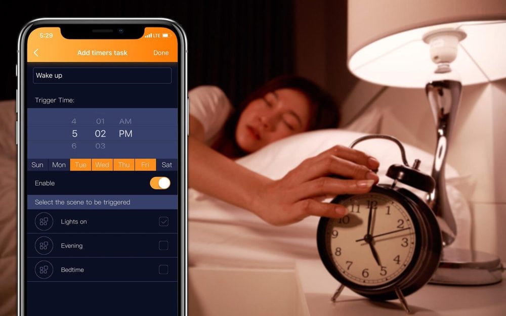 sleepy woman in bed with eyes closed extending hand to alarm clo