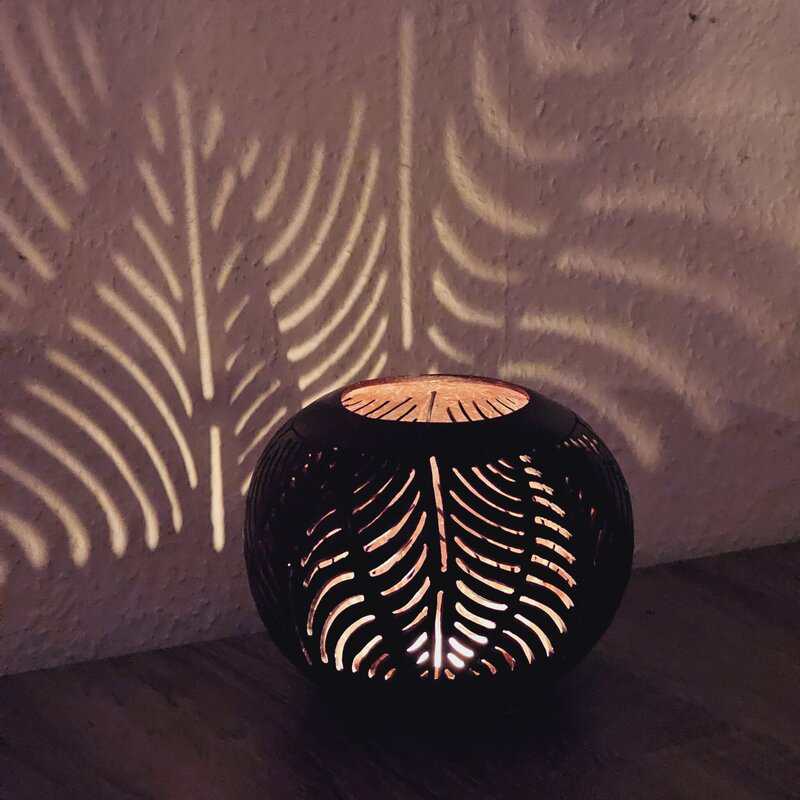 Knikkerlamp met bladpatroon, sfeervolle decoratie, roterende schaduwprojectie, LICHY LAMPEN design, handgemaakte decoratieve verlichting, ambachtelijk sfeerlicht, Zeeuws designlamp, unieke woonaccessoire, modern lichtobject, stijlvolle kamerverlichting, kamerdecoratie, milieuvriendelijke houten lamp, sfeervolle woonruimte, ambachtelijke interieuraccessoire, tuinverlichting, gezellige sfeer, woonkamer decor, unieke cadeau-idee.